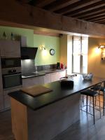 a kitchen with a large island in the middle at Aux Cornettes in Beaune