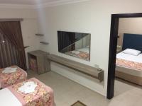 A bed or beds in a room at Hamle Hotel