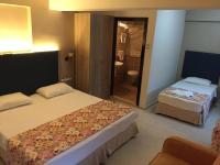 A bed or beds in a room at Hamle Hotel