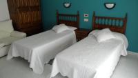 Posteľ alebo postele v izbe v ubytovaní Hostal La Paz