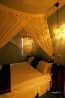 a bedroom with a canopy bed with curtains at Raid Garden Boutique Hotel in Magong