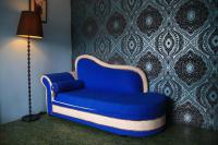 a blue chair in a room with a lamp at Raid Garden Boutique Hotel in Magong