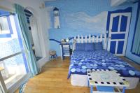 a bedroom with a bed in a blue room at Sea House in Magong