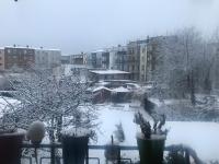 a view of a snow covered yard with buildings at Pension Karina Schwerin in Schwerin