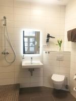 a bathroom with a toilet and a sink and a mirror at Pension Karina Schwerin in Schwerin