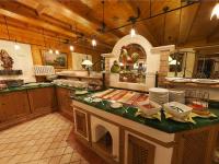 a kitchen with a counter with food on it at Alpenhotel Tirolerhof in Neustift im Stubaital