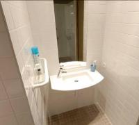 a white bathroom with a sink and a mirror at Temporesidence Cathedrale in Bayonne