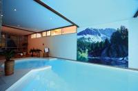 a swimming pool in a building with a painting on the wall at T2 RESIDENCE 3 ETOILES Piscine chauffée Sauna Hammam in Cauterets