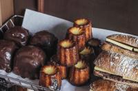 a tray of donuts and pastries on a table at Playce Camp Jeju in Seogwipo