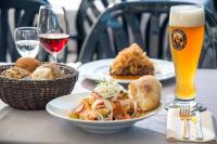 a table with plates of food and a glass of beer at Gasthof Ziegler Hotel & Restaurant in Lindau