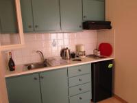 A kitchen or kitchenette at Kallopsia - Glifada Beach Menigos Resort by New Era