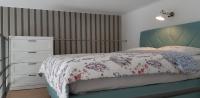 A bed or beds in a room at Tempo Life Apartman
