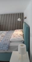 A bed or beds in a room at Tempo Life Apartman