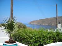a plant in a pot on a table with a view of the ocean at Gryspo&#39;s Hotel in Aegiali