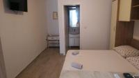 Posteľ alebo postele v izbe v ubytovaní Apartmani Dina