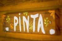 a sign that says pnm on a wooden wall at Carre Royal in Deshaies
