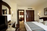 A bed or beds in a room at Hurghada Coral Beach Hotel