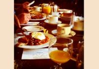 a table with plates of food and glasses of orange juice at Arlington Hotel O'Connell Bridge in Dublin