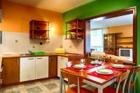 a kitchen with a table with chairs and a dining room at Apartments Medena in Matulji