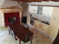 a kitchen with a wooden table and a stove top oven at Villa Broglia House in Verona