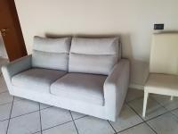 a couch sitting in a room next to a chair at Villa Broglia House in Verona