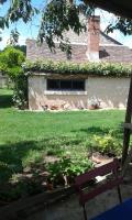 a bench in front of a house with plants at la vigneraie in Seigy