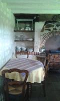 a dining room with a table and a kitchen at la vigneraie in Seigy