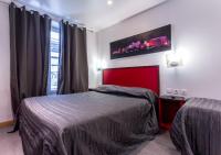 a bedroom with a bed and a red head board at Victory Hotel Galou in Paris