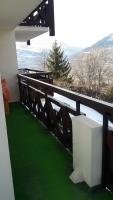 a balcony with green grass and a view of a mountain at Appartement 4 pers Saint Gervais les Bains in Saint-Gervais-les-Bains