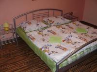 A bed or beds in a room at Penzion Chalupka