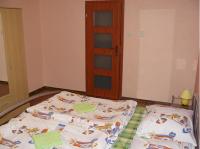 A bed or beds in a room at Penzion Chalupka