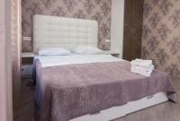 a bedroom with a large bed with a white headboard at Home Hotel Apartments on Mykhailivska Square - Kiev in Kyiv
