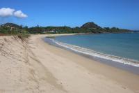 a beach with sand and the ocean on a clear day at Kenting Waterfront Hotel in Kenting