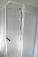 a shower with a shower head in a bathroom at Gasthof Zum Stausee in Engelskirchen