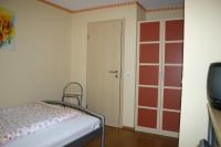 a bedroom with a bed and a door with red paint at Gasthof Zum Stausee in Engelskirchen