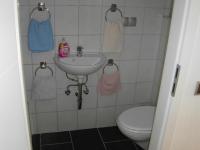 a bathroom with a sink and a toilet at Gasthof Zum Stausee in Engelskirchen