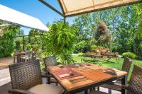 a wooden table and chairs on a patio at Expo Hotel Sofia - Free Airport Shuttle in Sofia