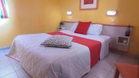 a bedroom with a large bed with red and white sheets at VVF Sud Vercors in Die