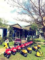 a group of toy motorcycles parked in front of a house at Follow Me designed B&amp;B in Dongshan