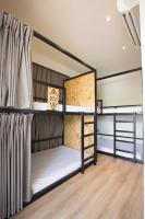 two bunk beds in a room with a wooden floor at Light Hostel - Tainan in Tainan