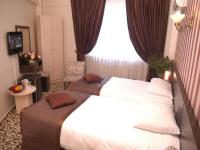 Cama o camas de una habitaci&oacute;n en Maya Hotel