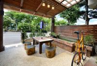 a bike parked under a pavilion with a table and a bike parked at Jinge Guest House in Jiji