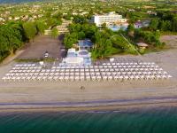 an aerial view of a beach with white umbrellas at Olympian Bay Grand Resort in Leptokaria