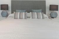 A bed or beds in a room at Ag Casa Del Mar Premium