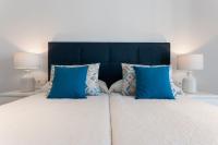 A bed or beds in a room at Ag Casa Del Mar Premium