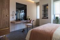 A bed or beds in a room at Perianth Hotel