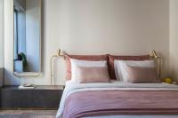 A bed or beds in a room at Perianth Hotel