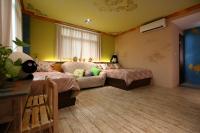 a bedroom with two beds and a couch at Sweet Heart B&amp;B in Ji&#39;an