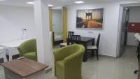 a room with a table and chairs and a dining room at Apartment 18 in Pančevo