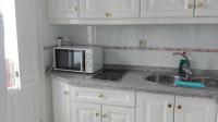 A kitchen or kitchenette at Apartamentos Oscar
